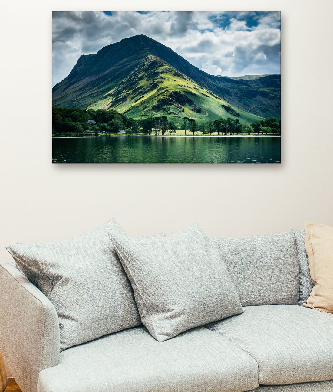 A canvas print of a Lake District mountain and lake, hanging above a sofa